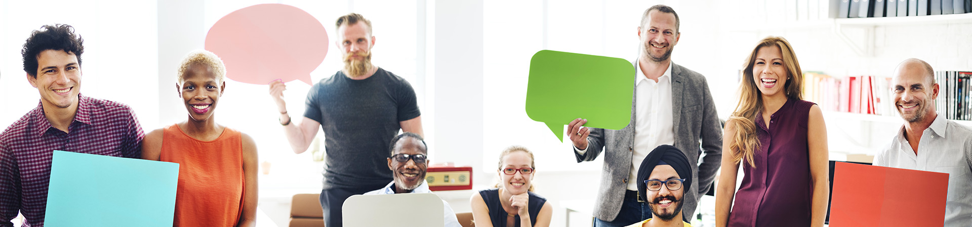 Group of diverse office workers holding up speech bubbles